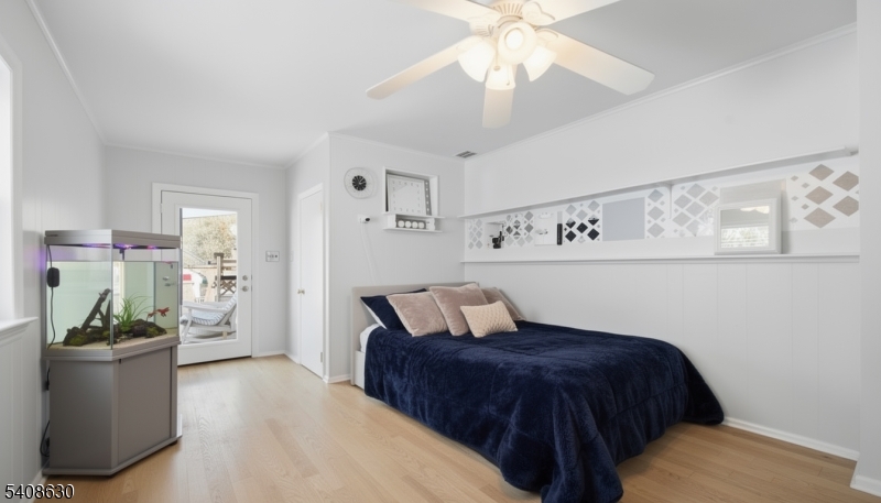 435 Spring Mills Road Milford, NJ 08848 - Photo 25 of 39 a bedroom with a bed and a chandelier