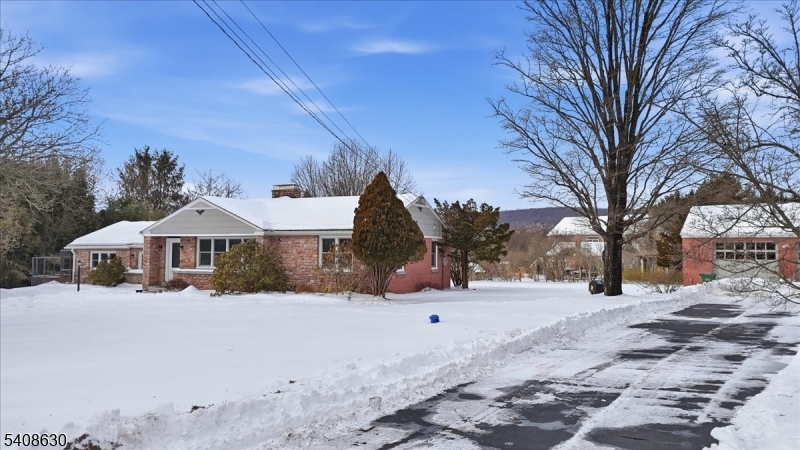 435 Spring Mills Road Milford, NJ 08848 - Photo 3 of 39 a front view of a house with a yard covered in snow