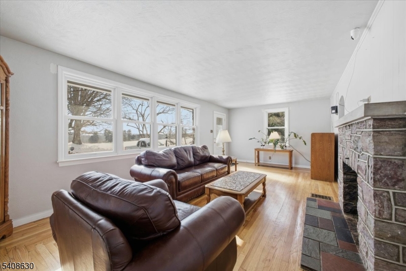 435 Spring Mills Road Milford, NJ 08848 - Photo 7 of 39 a living room with furniture a large window and a fireplace
