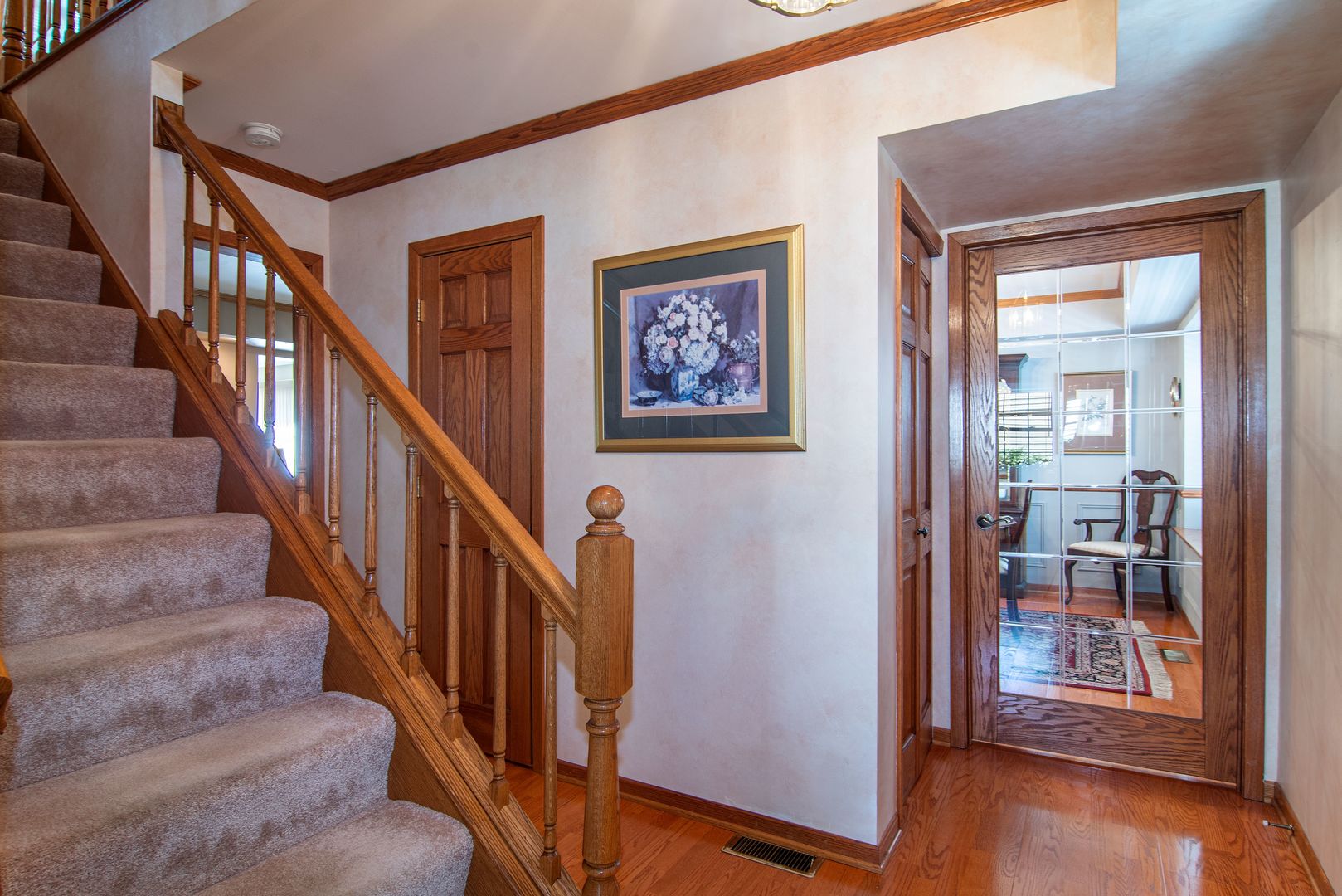73 Foxcroft Road Naperville, IL 60565 - Photo 17 of 37 a view of staircase with lots of frames and flower vase