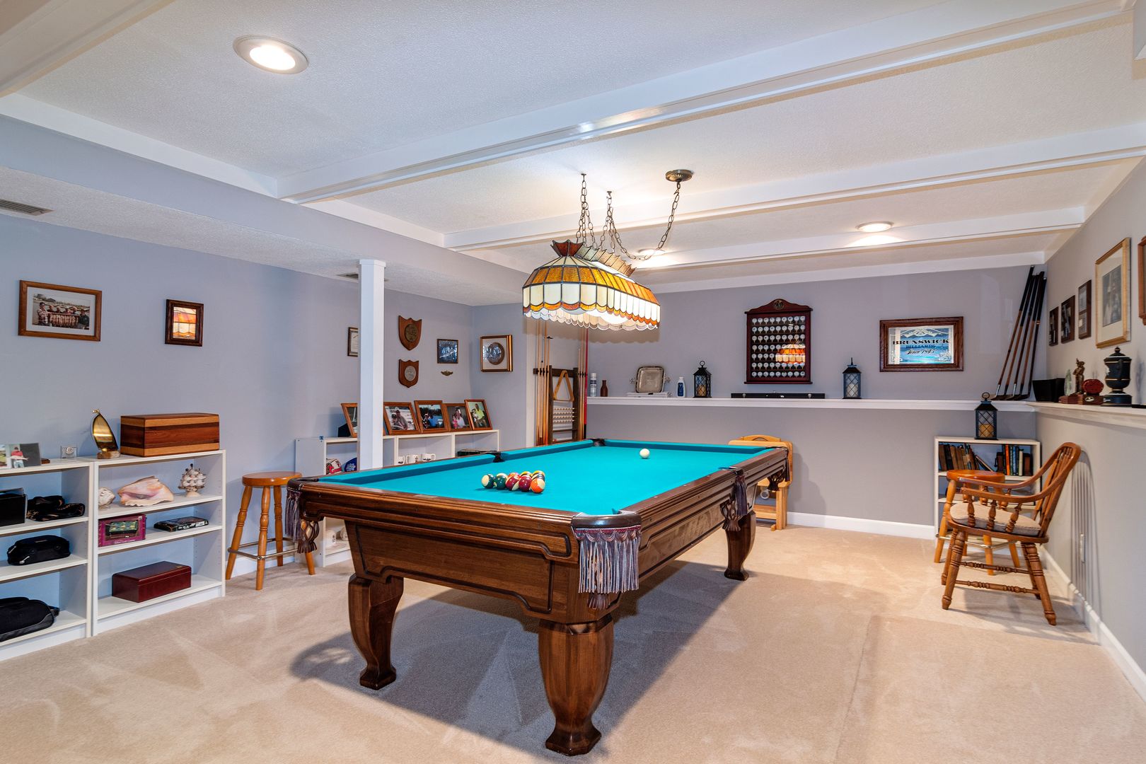 73 Foxcroft Road Naperville, IL 60565 - Photo 26 of 37 a room with furniture a chandelier and a flat screen tv