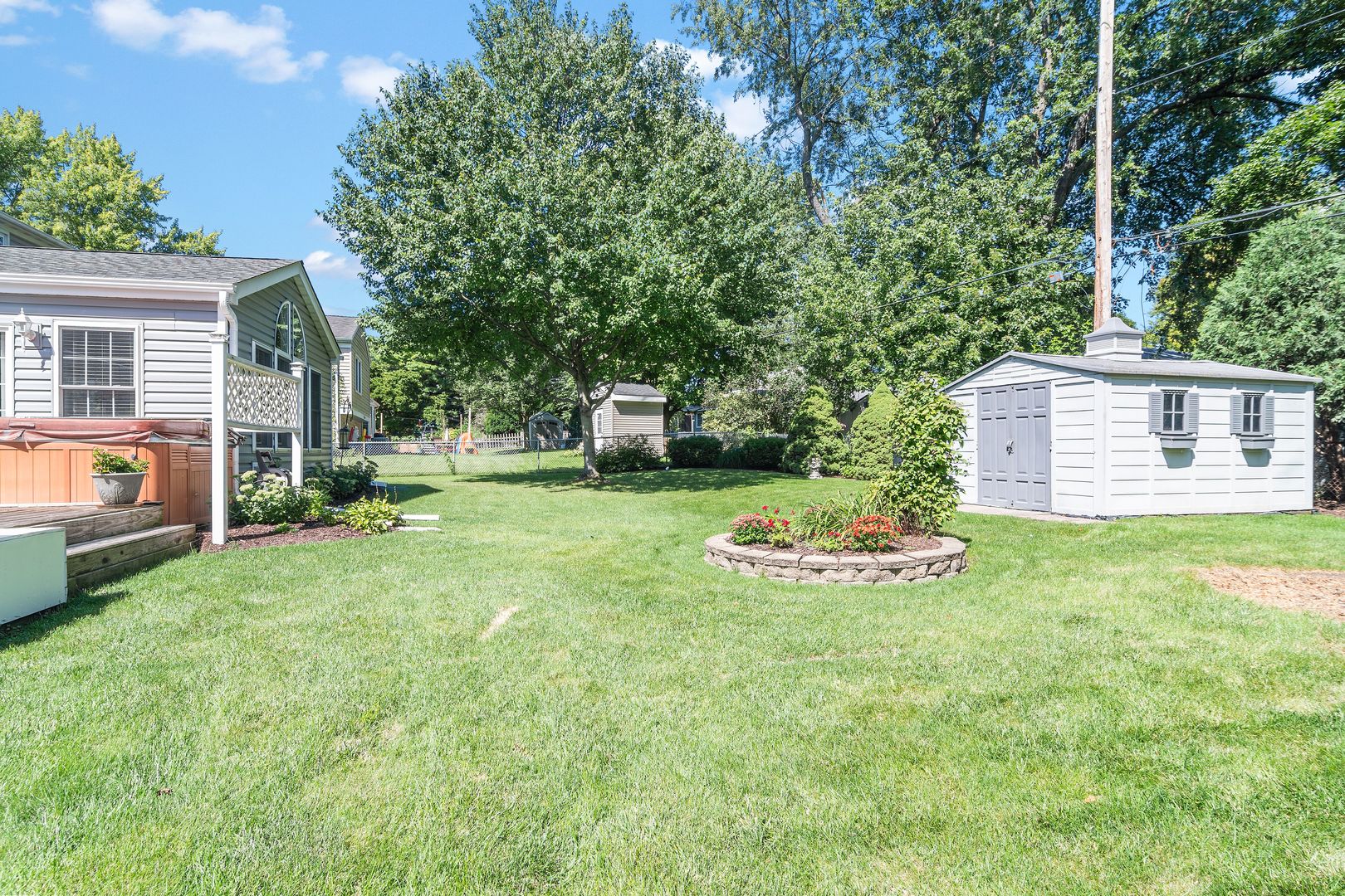 73 Foxcroft Road Naperville, IL 60565 - Photo 32 of 37 a view of a backyard with table and chairs and a grill