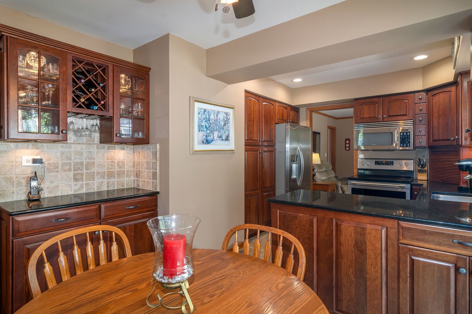 73 Foxcroft Road Naperville, IL 60565 - Photo 6 of 37 a kitchen with stainless steel appliances kitchen island granite countertop a refrigerator a stove a sink dishwasher with a dining table and chairs