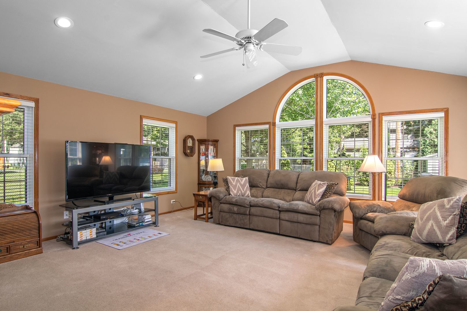 73 Foxcroft Road Naperville, IL 60565 - Photo 9 of 37 a living room with furniture a flat screen tv and a large window