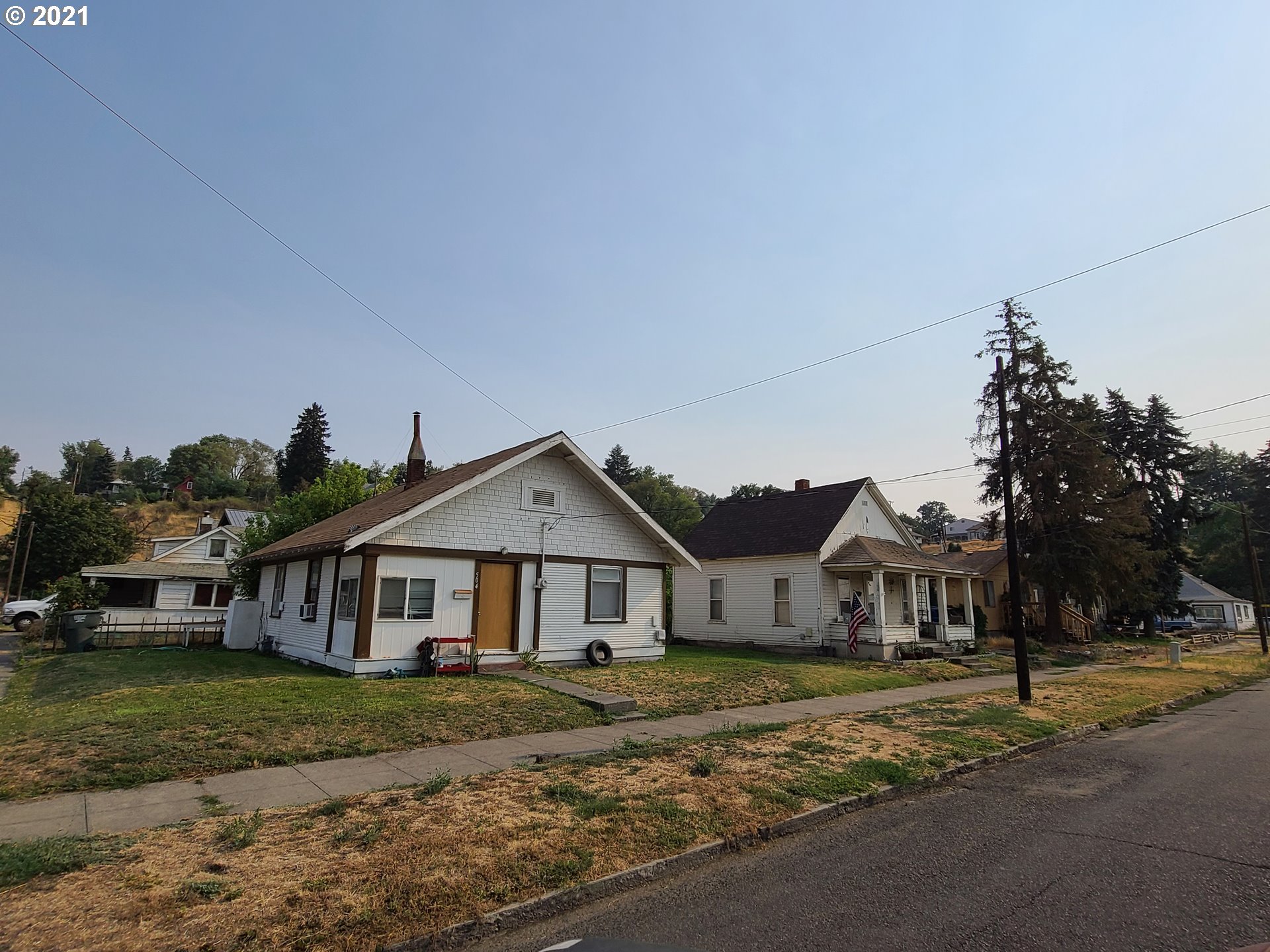 506 Southwest Goodwin Avenue Pendleton, OR 97801 - Photo 1 of 18 a view of a big house with a big yard plants and large trees