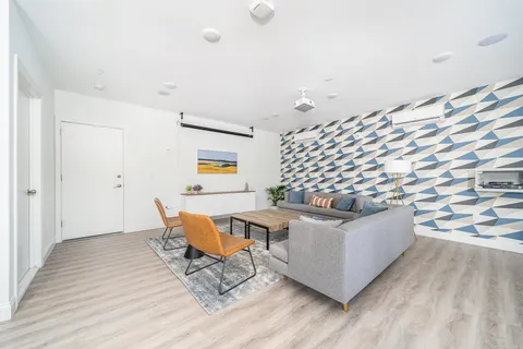 a living room with furniture and a potted plant