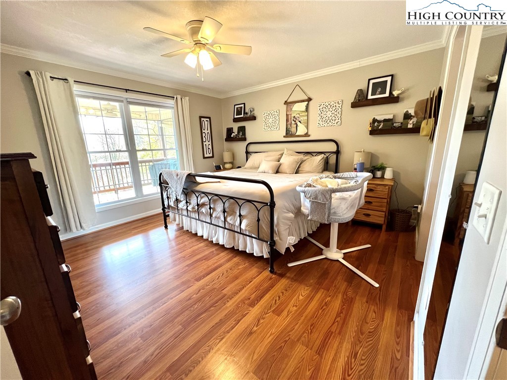 1534 Longhope Road Todd, NC 28684 - Photo 13 of 35 a spacious bedroom with a bed and wooden floor