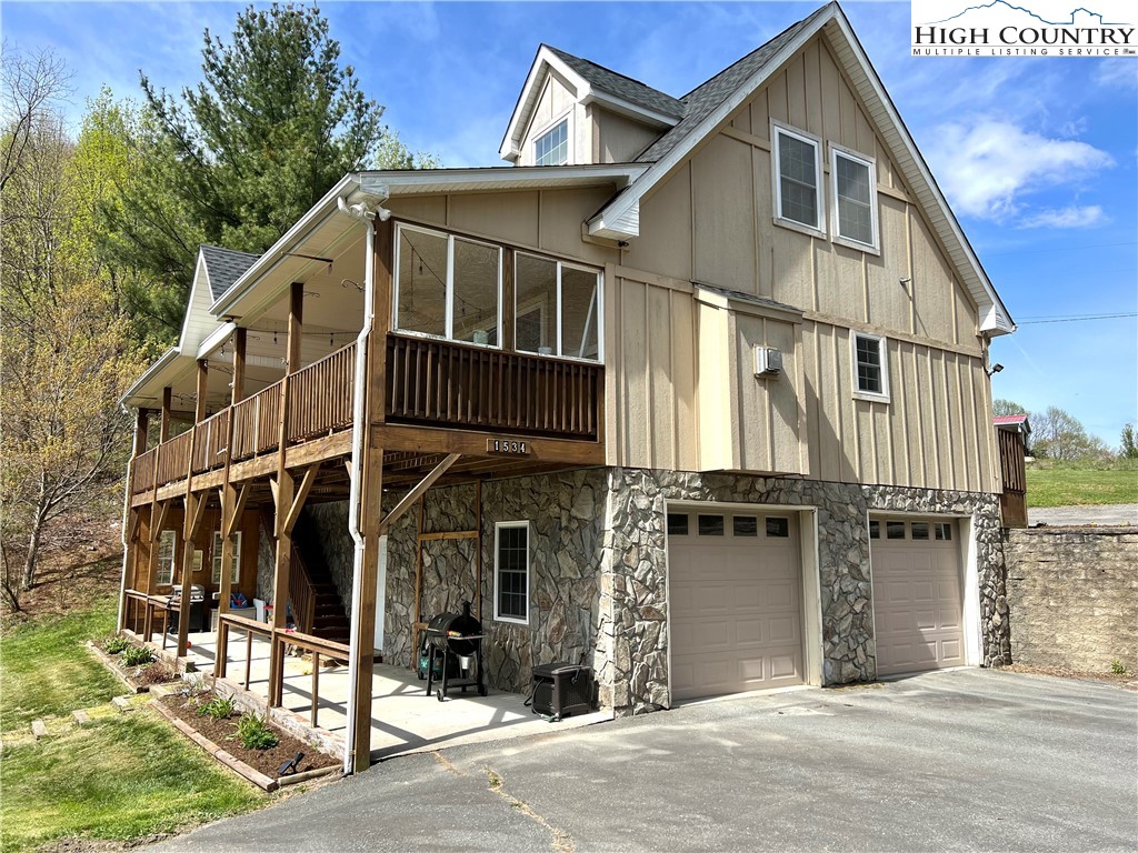 1534 Longhope Road Todd, NC 28684 - Photo 2 of 35 a view of a house with a garage and balcony