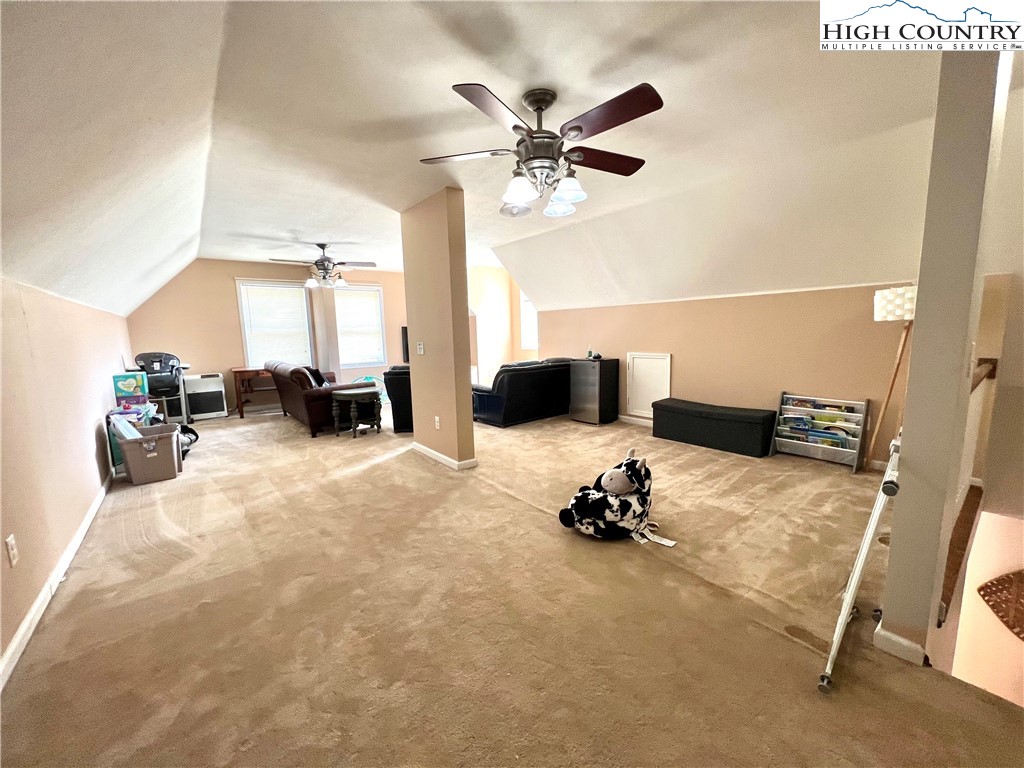 1534 Longhope Road Todd, NC 28684 - Photo 25 of 35 a bed room with a bed furniture and a chandelier