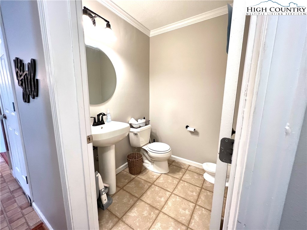1534 Longhope Road Todd, NC 28684 - Photo 27 of 35 a bathroom with a toilet and a mirror
