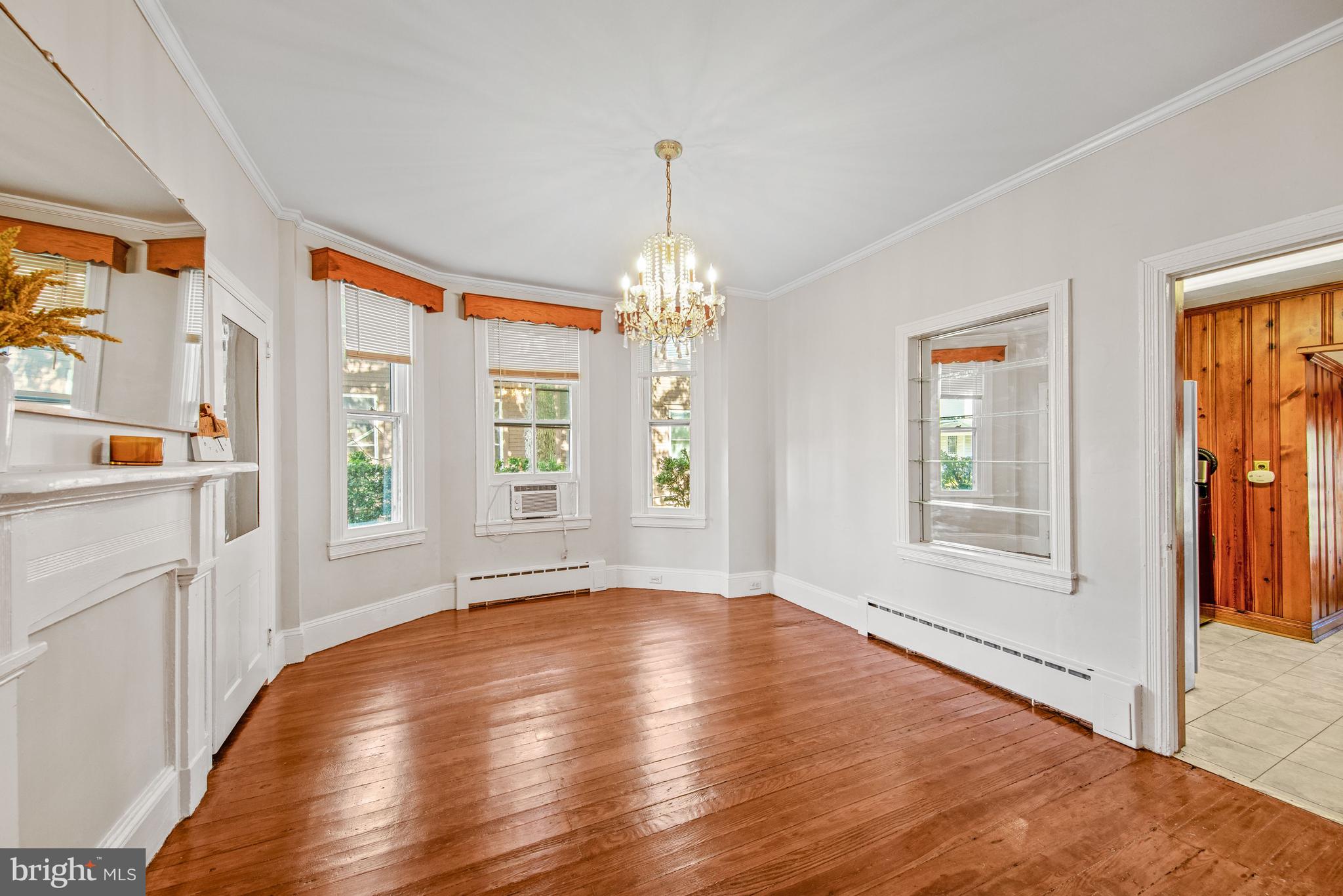 817 Locust Street Cambridge, MD 21613 - Photo 11 of 44 a view of an empty room with window and wooden floor