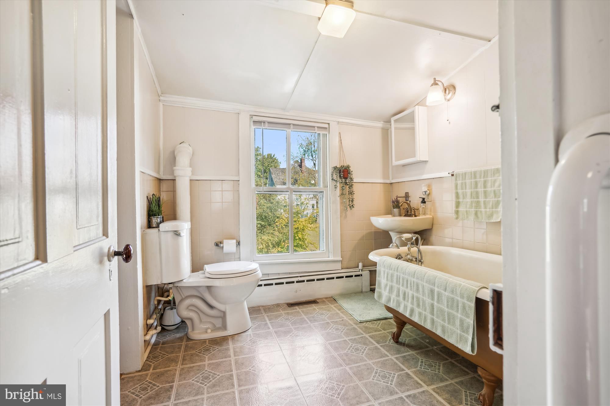 817 Locust Street Cambridge, MD 21613 - Photo 14 of 44 a living room with furniture and a large window with white walls