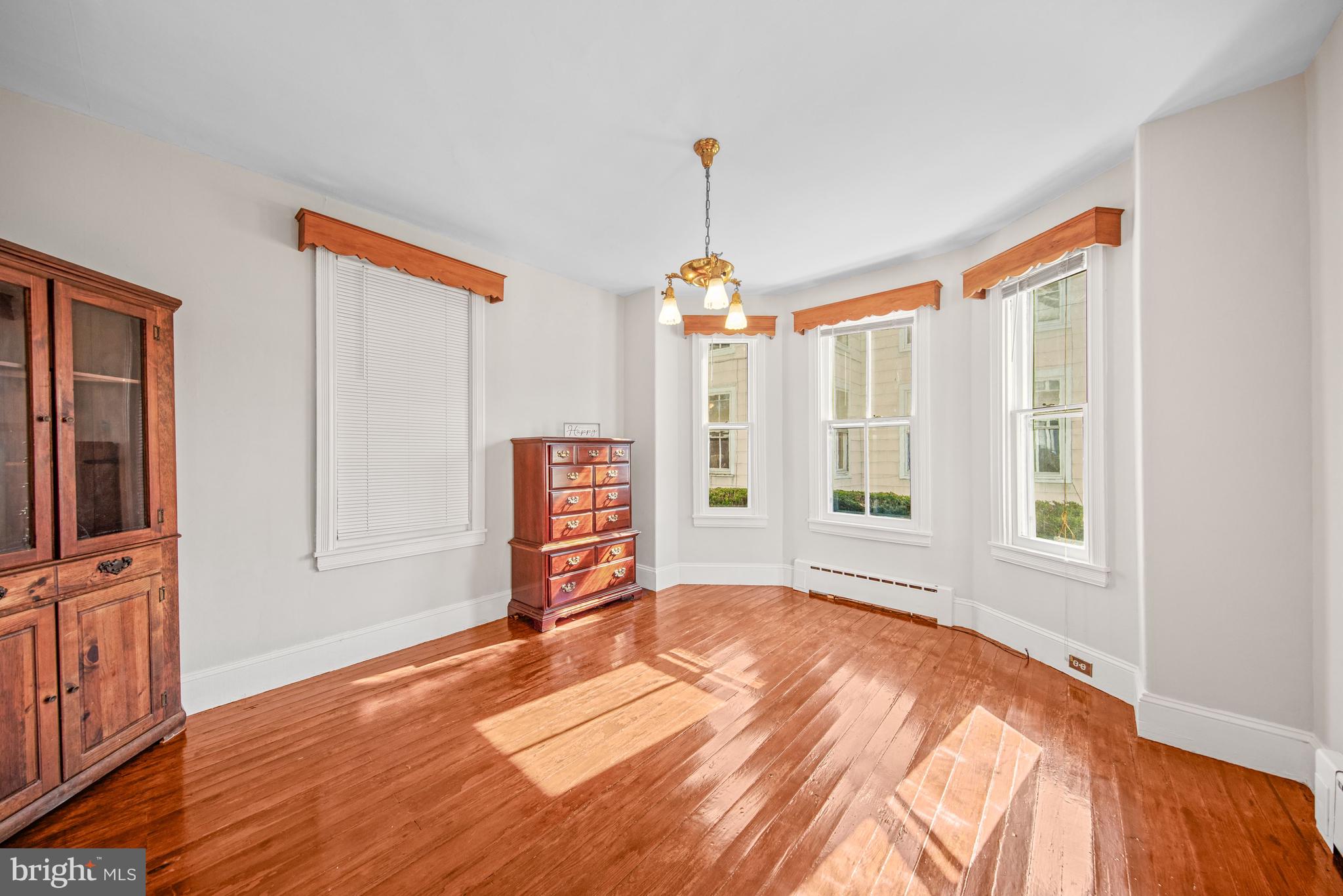 817 Locust Street Cambridge, MD 21613 - Photo 15 of 44 a view of an empty room with a window and wooden floor