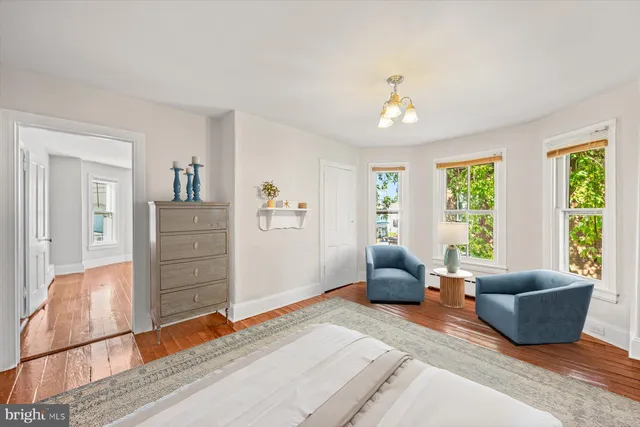 a living room with furniture windows and a flat screen tv