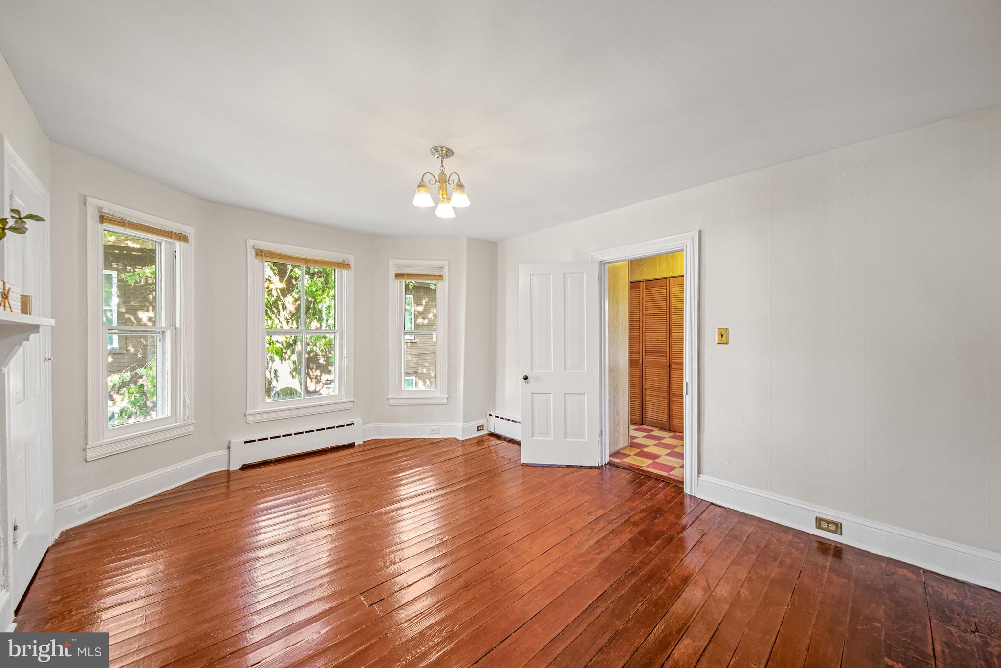 817 Locust Street Cambridge, MD 21613 - Photo 18 of 44 an empty room with wooden floor and windows