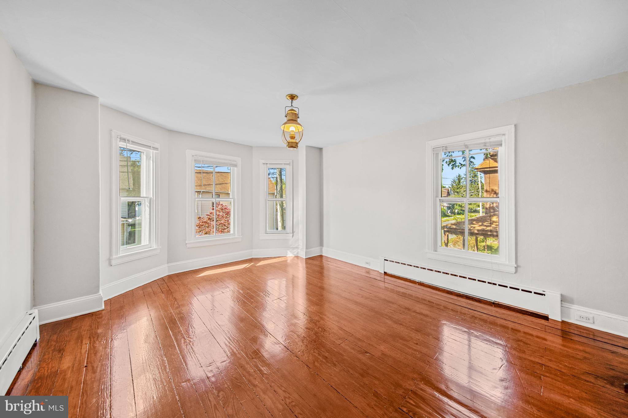 817 Locust Street Cambridge, MD 21613 - Photo 19 of 44 a view of an empty room with window and wooden floor
