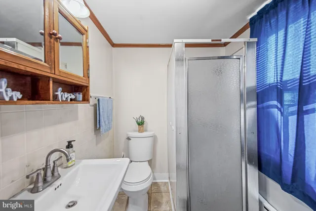 a white toilet sitting next to a bathroom sink