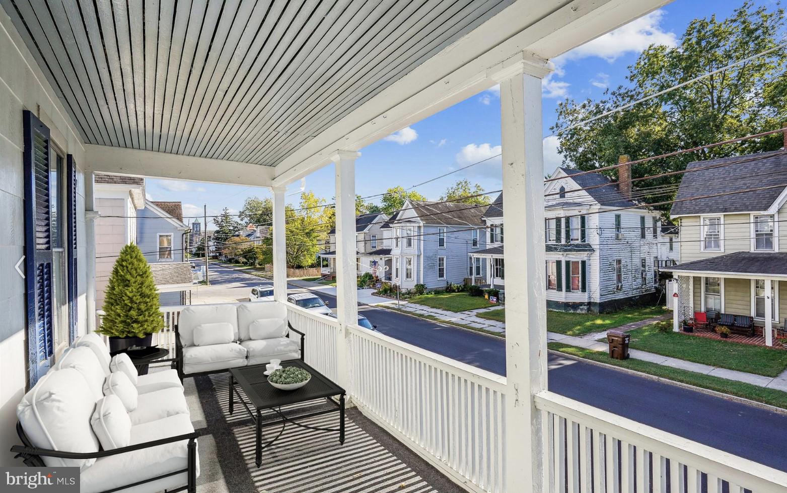 817 Locust Street Cambridge, MD 21613 - Photo 24 of 44 a view of a patio with couches table and chairs and potted plants
