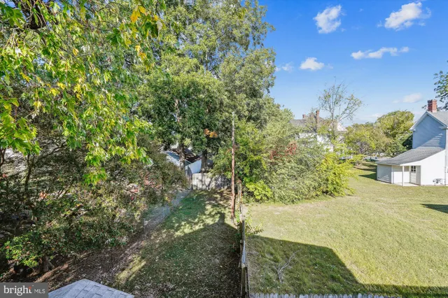 a view of a backyard with sitting area