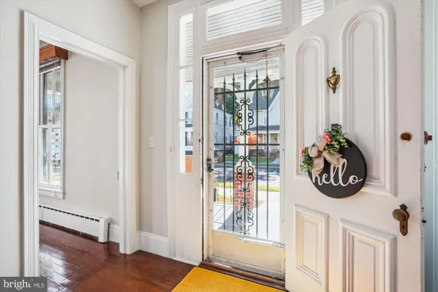 a front view of a house with wooden floor and windows