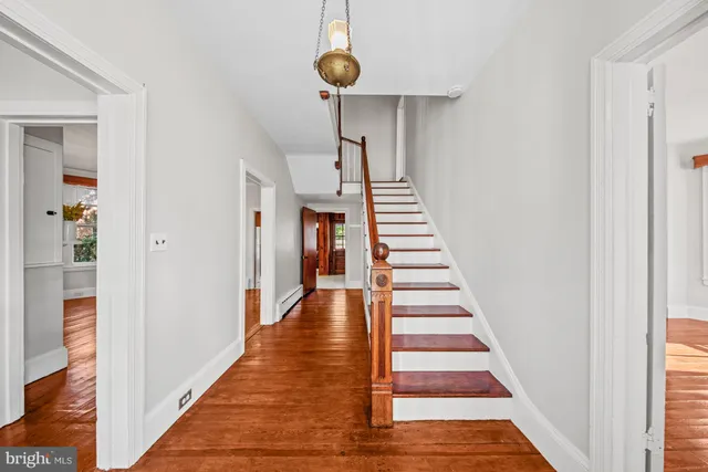 a view of entryway and hall with wooden floor