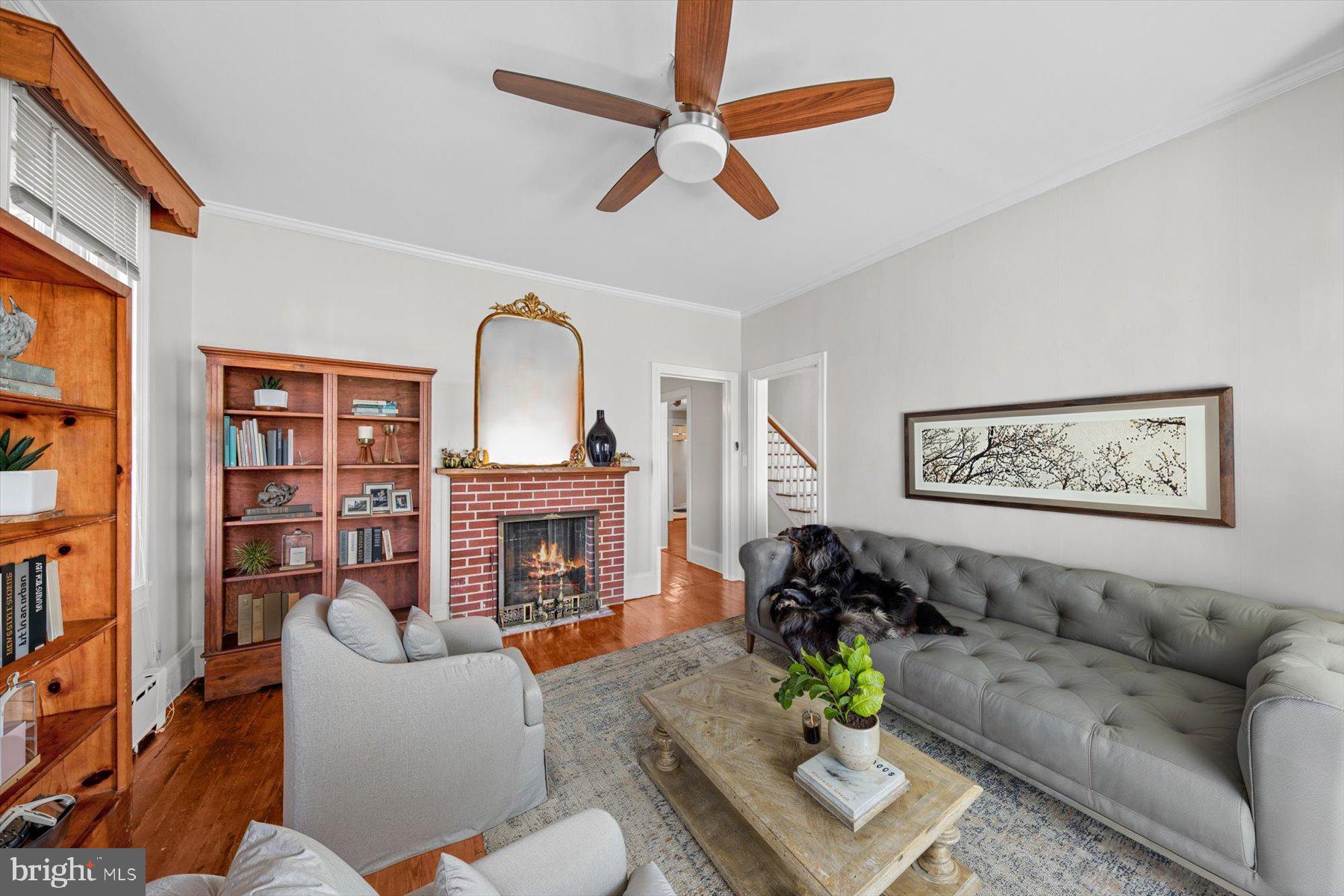 817 Locust Street Cambridge, MD 21613 - Photo 8 of 44 a living room with fireplace furniture and a wooden floor