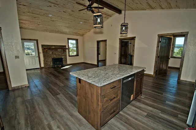 an open kitchen with sink and refrigerator