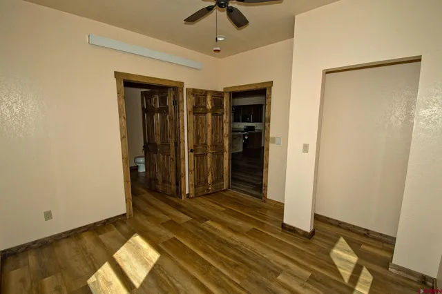 a view of empty room with wooden floor