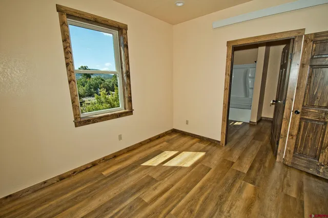 a view of an empty room and wooden floor