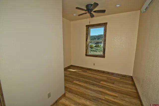 a view of room with window and ceiling fan