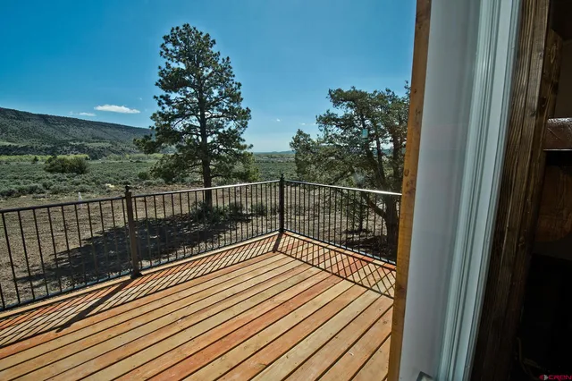 a view of balcony with wooden floor