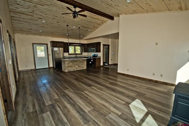 a view of a livingroom with furniture wooden floor and window