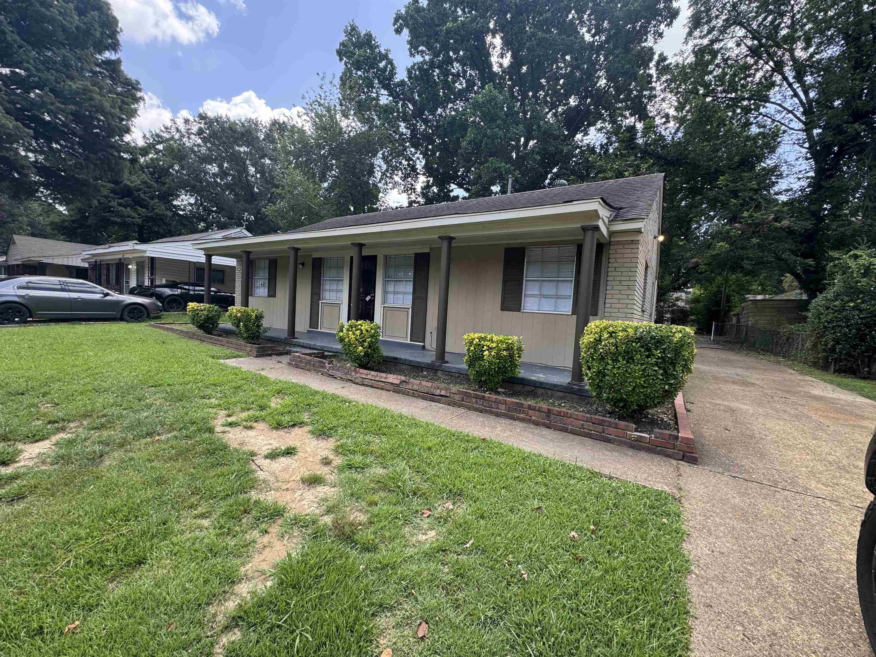 Bungalow with a porch and a front lawn