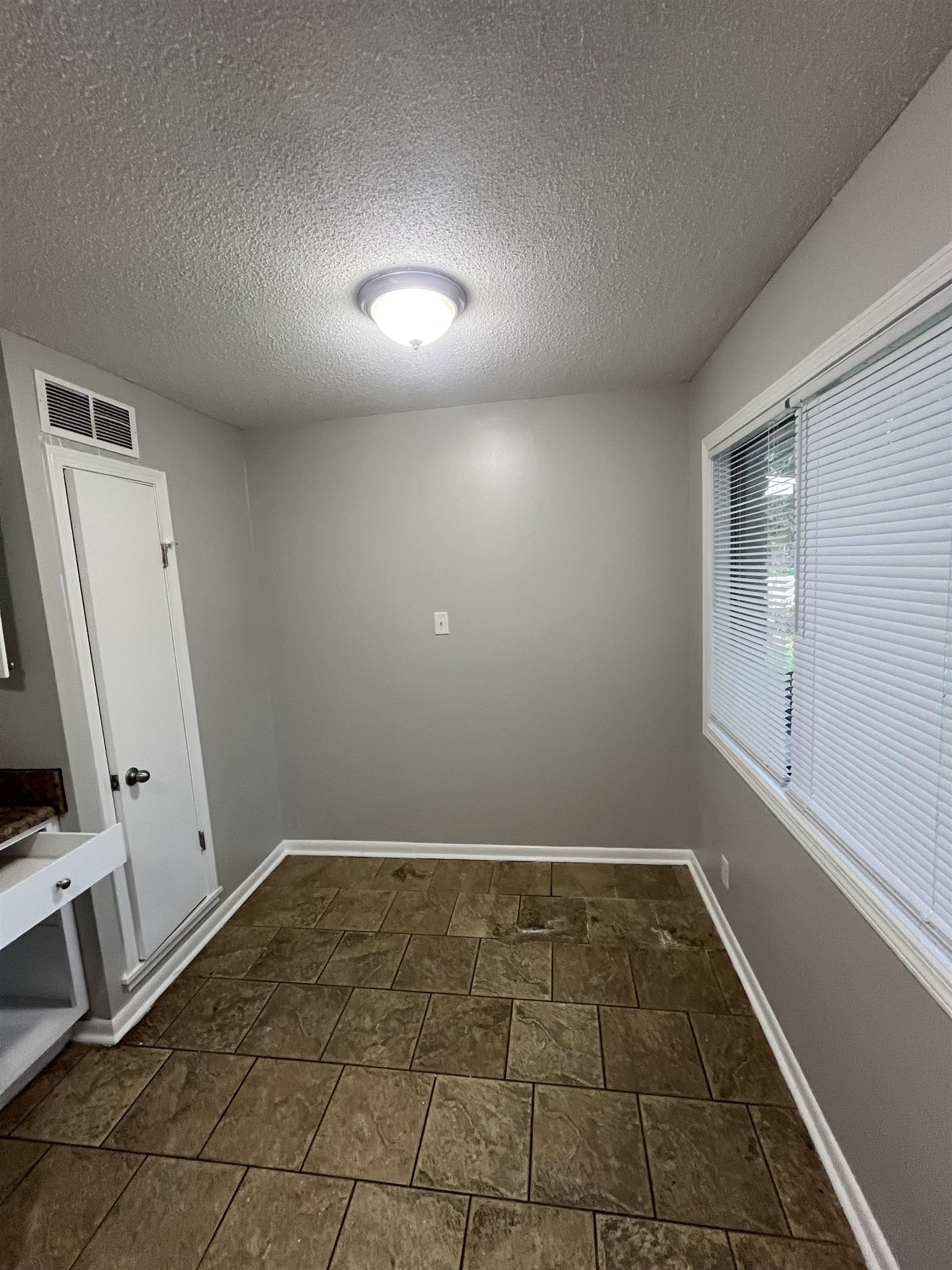 4173 Cottonwood Road Memphis, TN 38118 - Photo 2 of 13 Empty room with a textured ceiling and baseboards