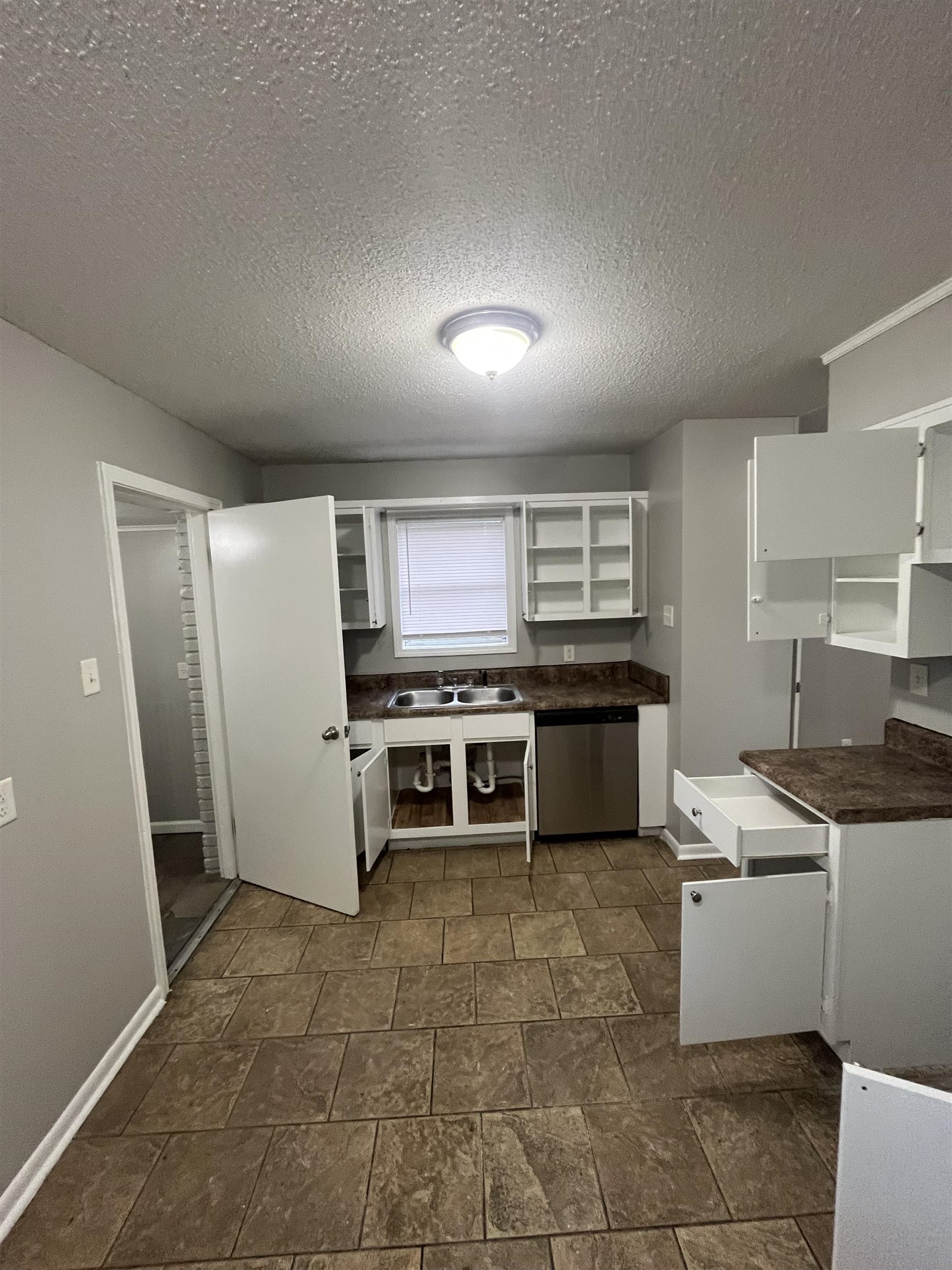 4173 Cottonwood Road Memphis, TN 38118 - Photo 10 of 13 a kitchen with stainless steel appliances granite countertop a stove a sink and a refrigerator