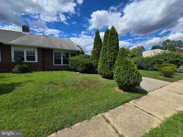 a front view of house with a garden