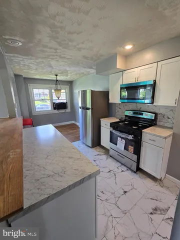 a kitchen with stainless steel appliances a stove a refrigerator and a sink
