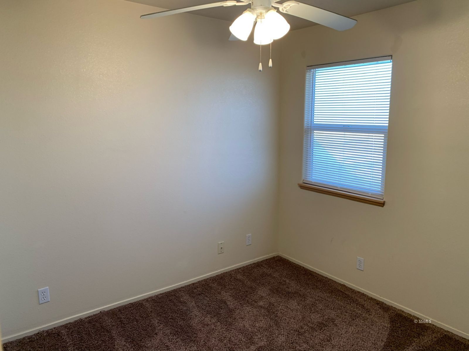 1640 South Mahan Street Ridgecrest, CA 93555 - Photo 14 of 27 an empty room with a chandelier fan