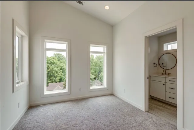 an empty room with windows and natural light