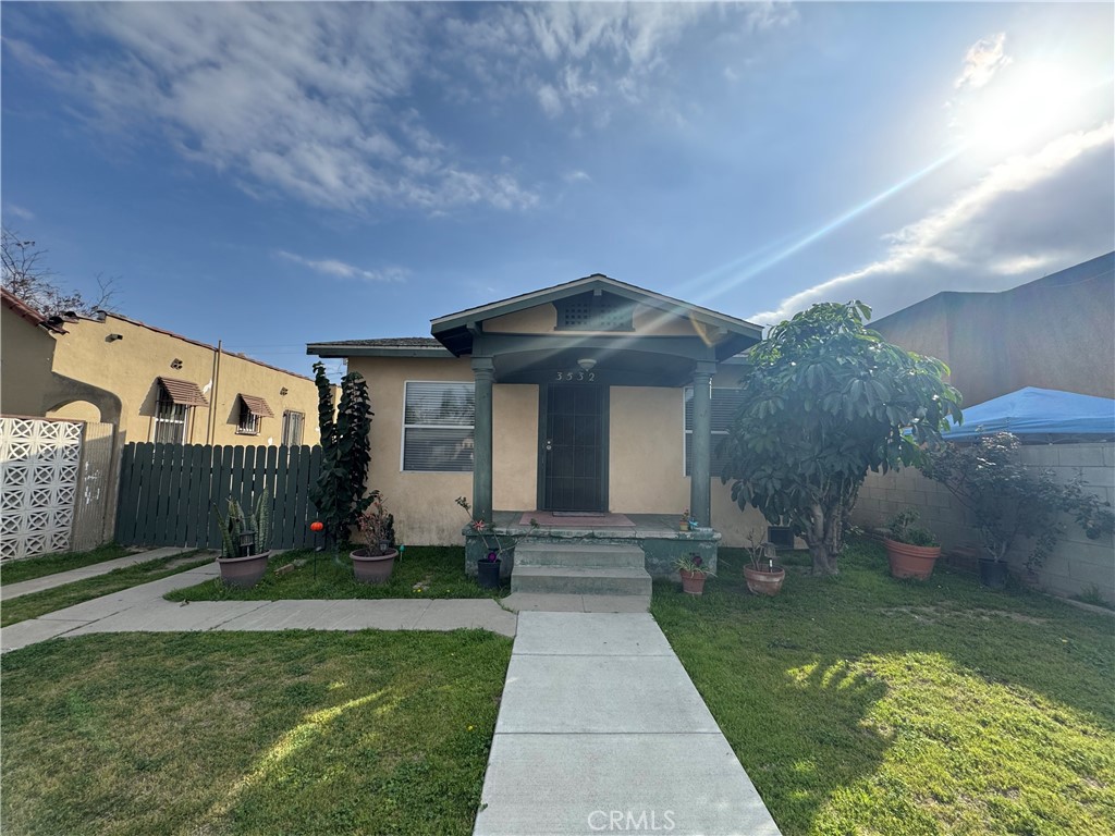 3532 East 53rd Street Maywood, CA 90270 - Photo 1 of 10 a front view of a house with a yard