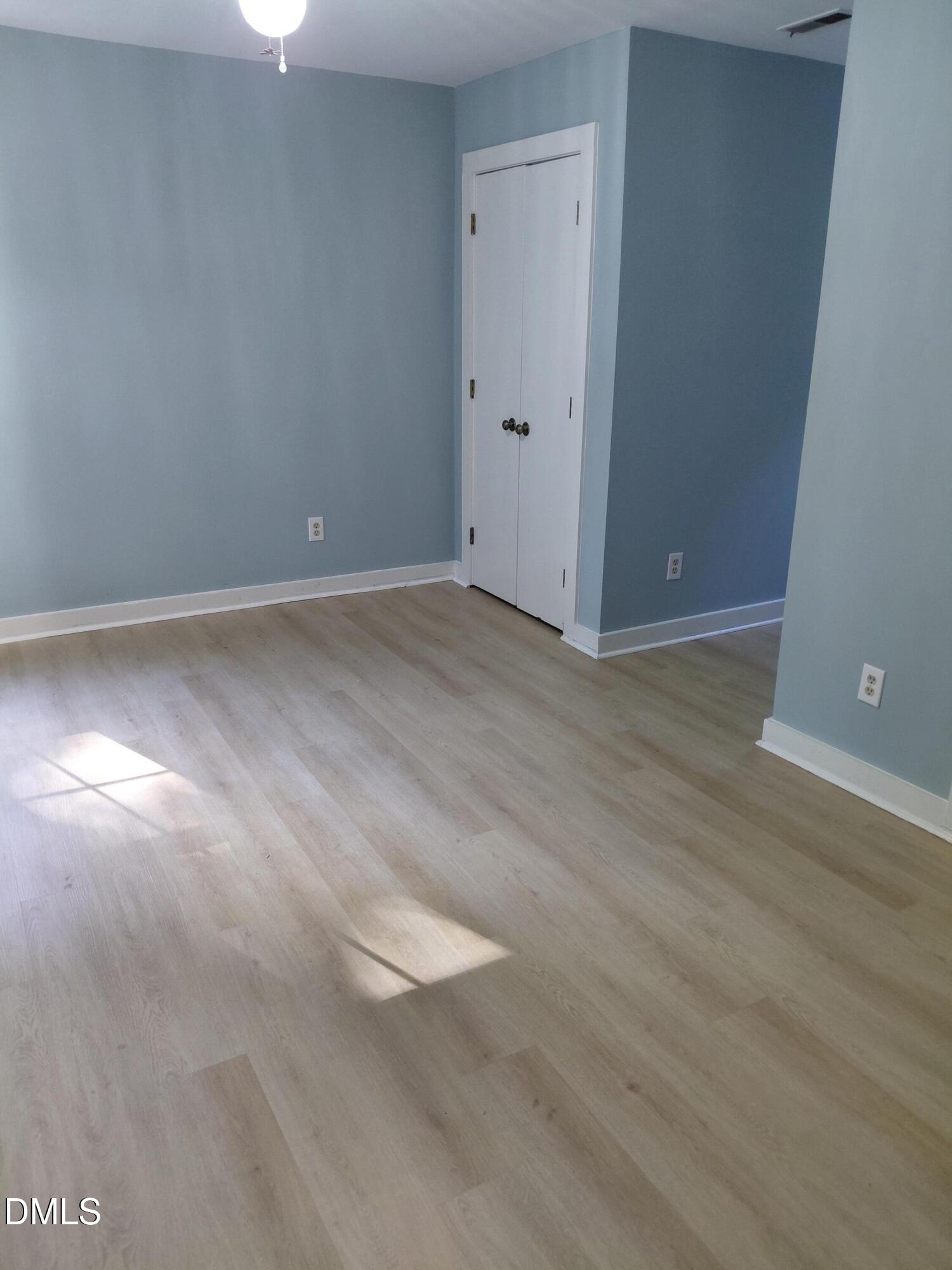 804 Olive Street Apex, NC 27502 - Photo 40 of 60 a view of an empty room with wooden floor