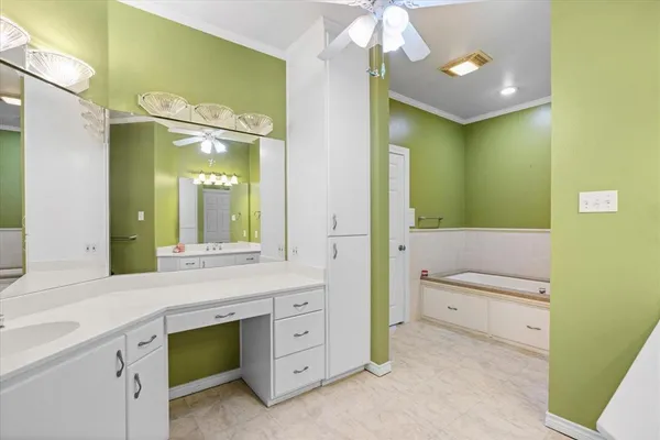a bathroom with a granite countertop sink mirror and a bathtub