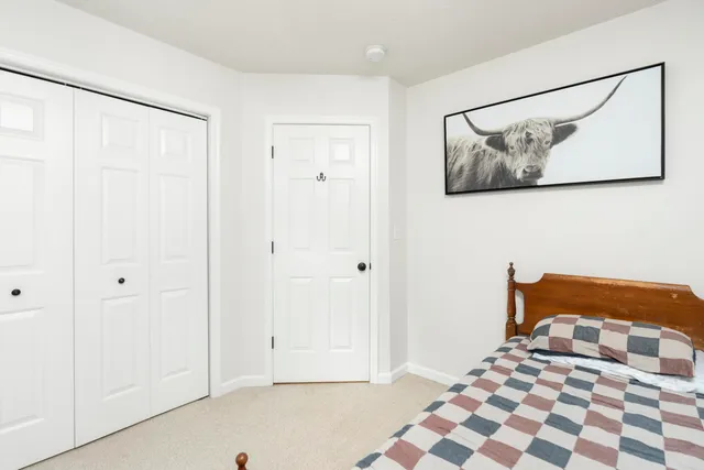 a view of a patio with table and chairs and floor to ceiling window