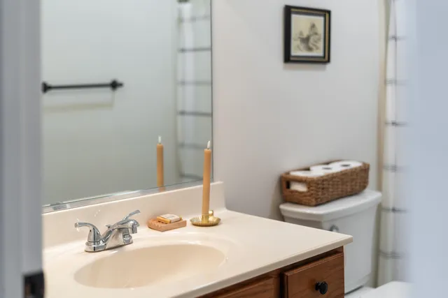 a view of house with backyard and trees in the background