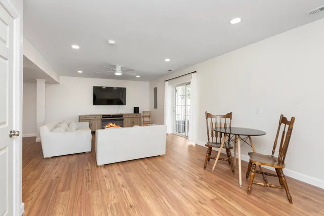 a view of a patio with table and chairs with wooden floor and fence