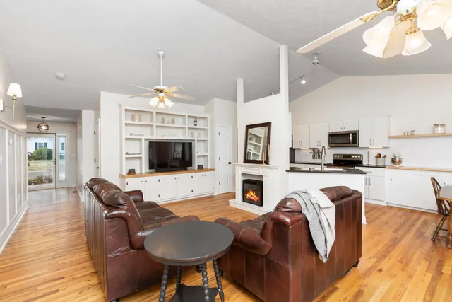 a kitchen with stainless steel appliances granite countertop a table and chairs in it