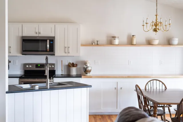 a kitchen with granite countertop a stove and a microwave