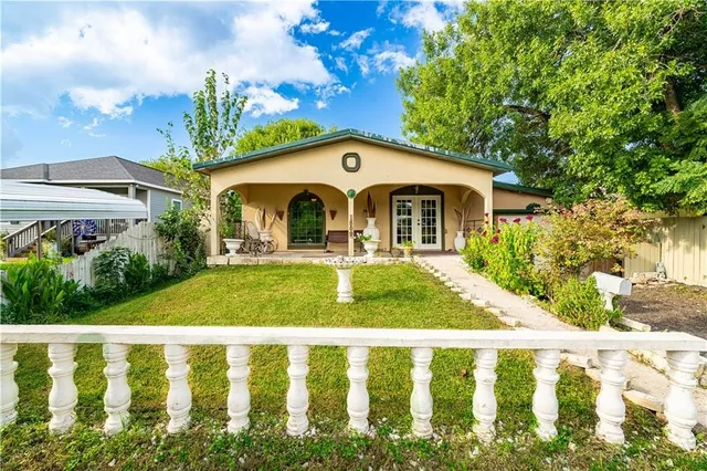 a front view of a house with garden