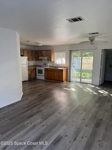 a view of a kitchen with a stove cabinets and a wooden floor