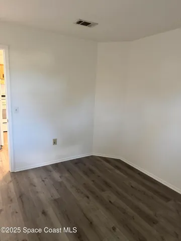 an empty room with wooden floor
